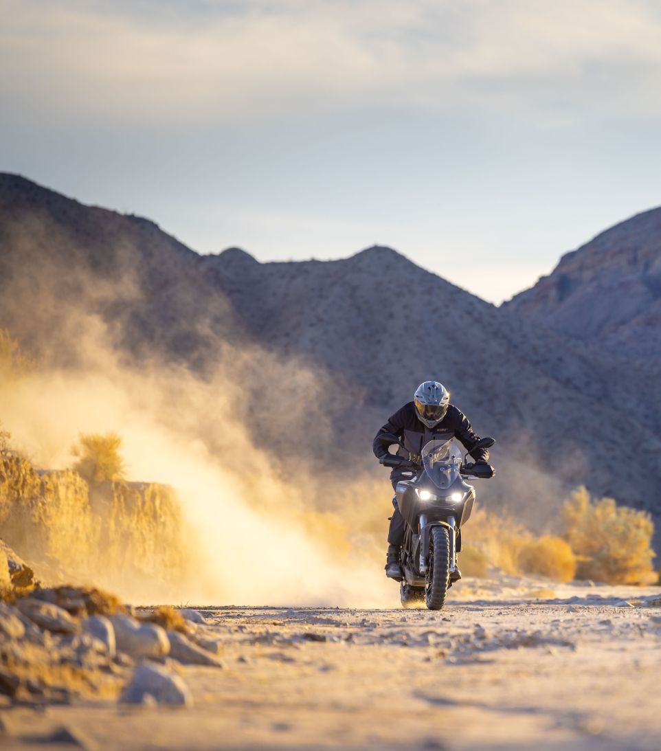 NORU adventure rider beside a motorcycle