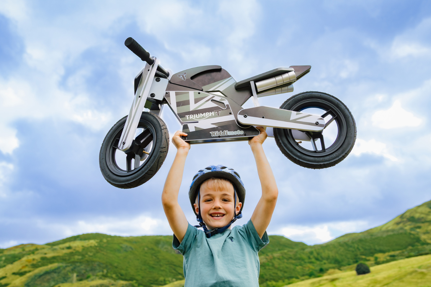 Young rider holding a Kiddimoto balance bike